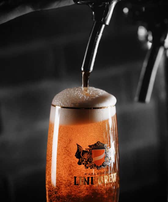 Beer being poured into a Line Brew branded glass
