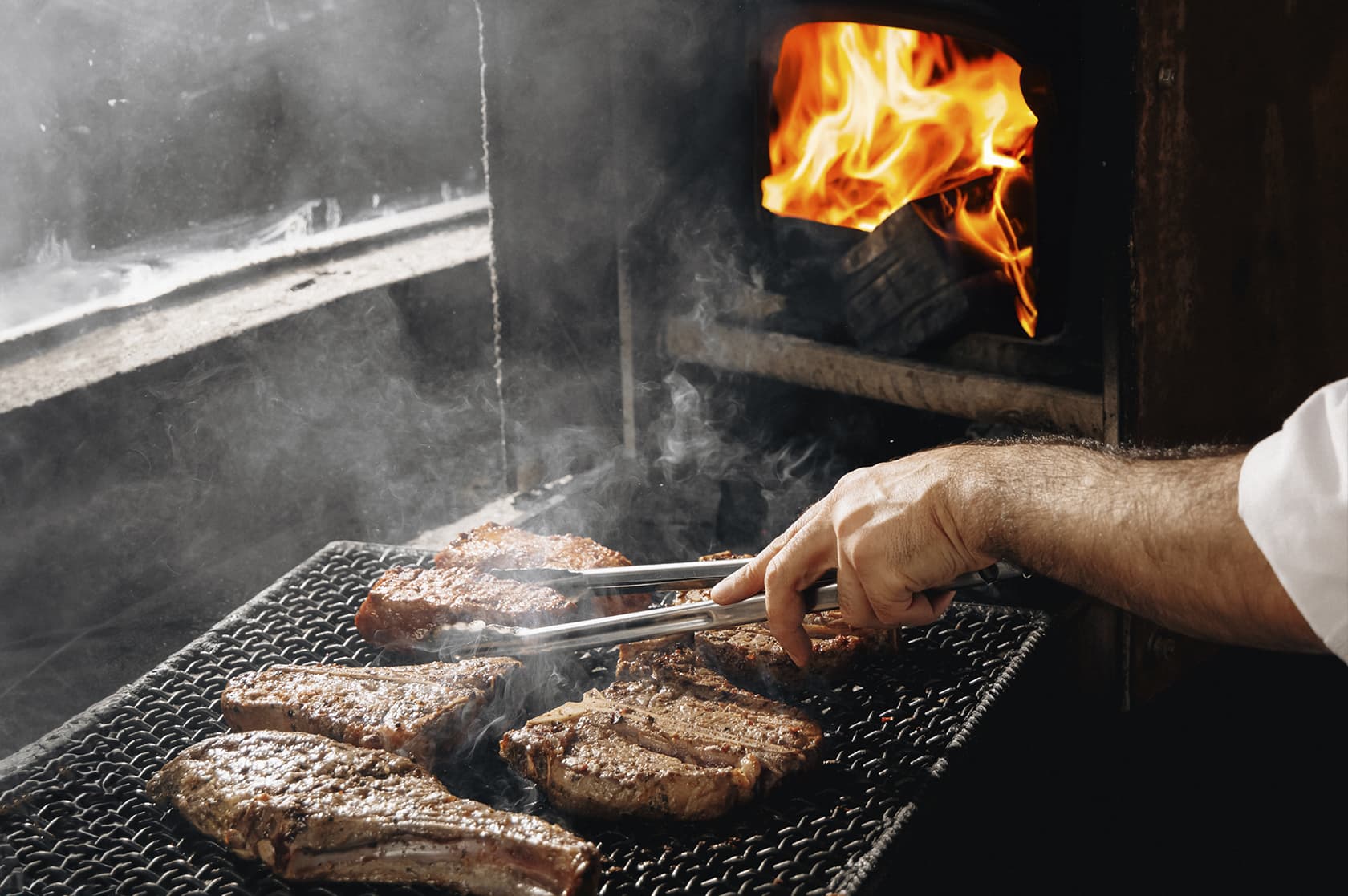 Steaks on the grill over an open fire